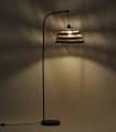 Le lampadaire Denva crée une ambiance chaleureuse avec un jeu d’ombres élégant sur le mur.